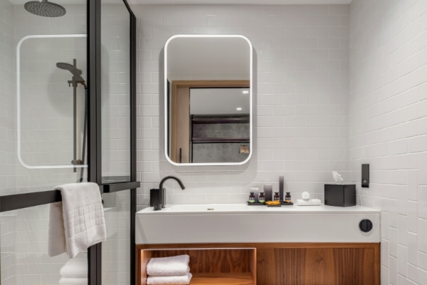 Canopy by Hilton London City - a bathroom with a mirror and a sink