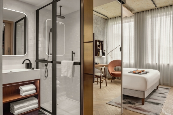 Canopy by Hilton London City - a bathroom with a shower and a desk