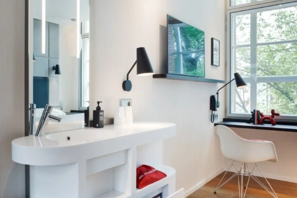 citizenM Amstel Amsterdam - a white room with a mirror and a white counter