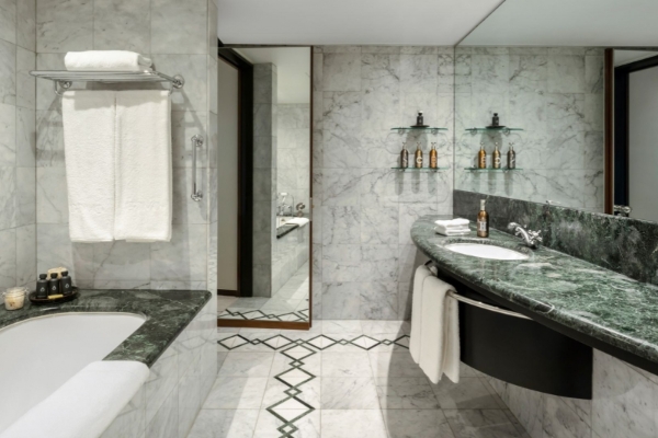 COMO The Halkin, London - a bathroom with marble tiles and a sink