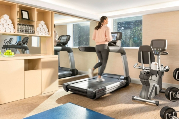 COMO The Halkin, London - a woman running on a treadmill in a gym