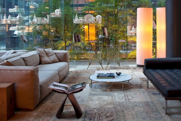 Conservatorium Hotel - a living room with a couch and a coffee table