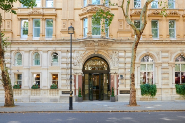 Corinthia Hotel - a building with a tree and a street light