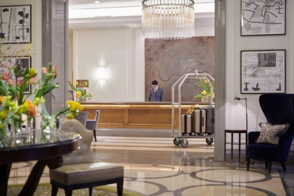 Corinthia Hotel - a man standing at a reception desk