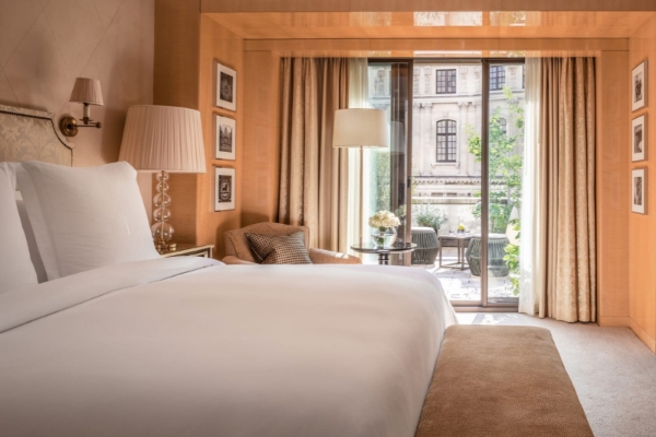 Four Seasons Hotel London at Park Lane - a bed in a room with a glass door