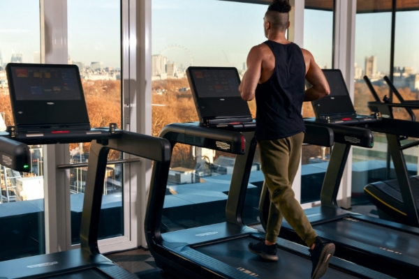 Four Seasons Hotel London at Park Lane - a man running on treadmills in a gym