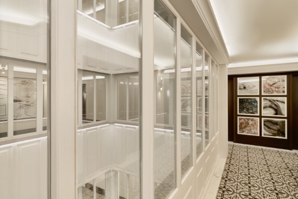 H10 Madison - a hallway with carpet and windows, looking onto a central atrium