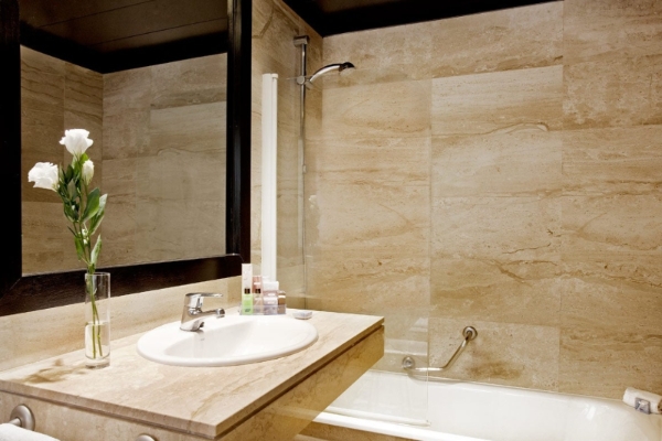 H10 Montcada Boutique Hotel - a bathroom with a sink and shower