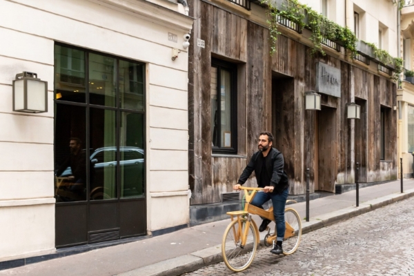 Hidden Hotel - a man riding a bicycle on a street