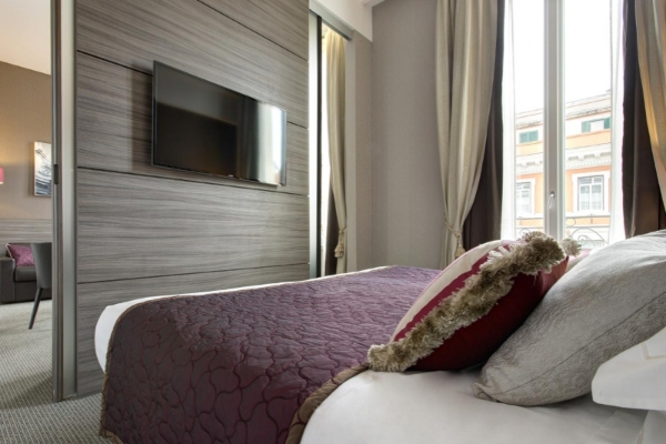 Hotel Artemide - Bedroom with contemporary furnishings and plush bedding.