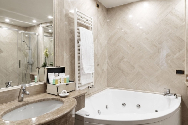 Hotel Barocco - Marble bathroom with modern fixtures.