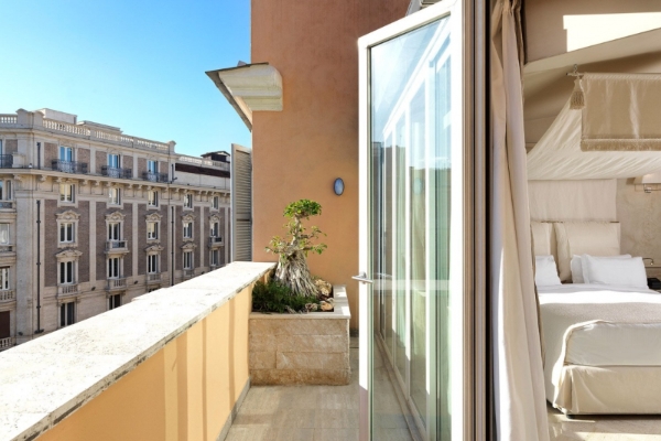 Hotel Barocco - Stylish hotel bedroom with terrace and view of Rome's landmarks.