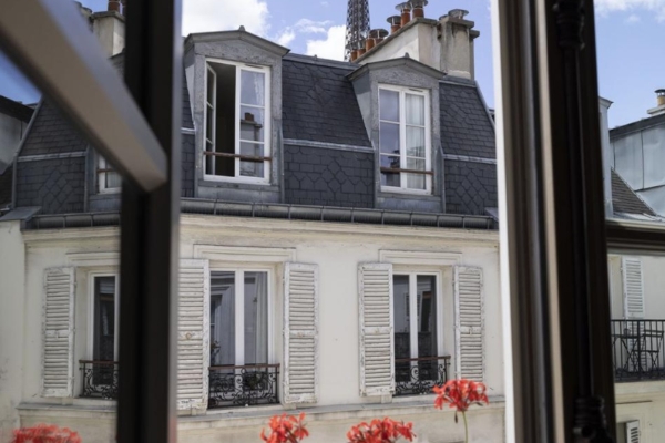 Hotel de Londres Eiffel - a window with a tower in the background