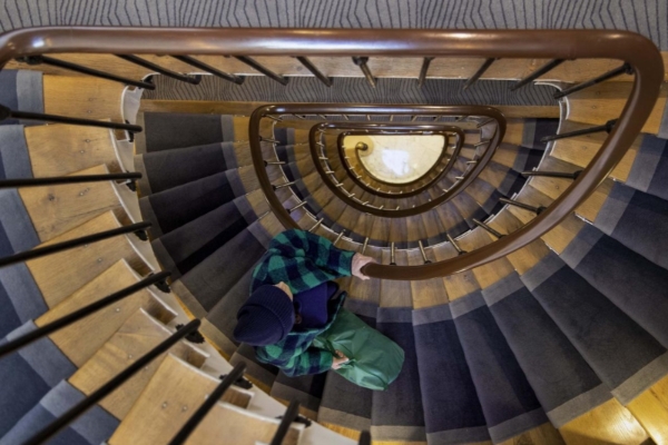 Hotel des Arts - Montmartre - a person on a spiral staircase