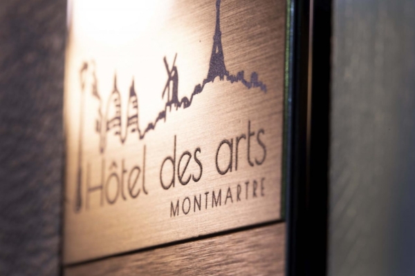 Hotel des Arts - Montmartre - a sign with a picture of a city