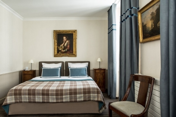 Hotel d'Orsay - Esprit de France - a bed with a chair and a painting on the wall