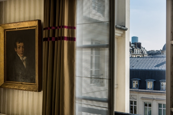 Hotel d'Orsay - Esprit de France - a window with blinds and a picture on the wall