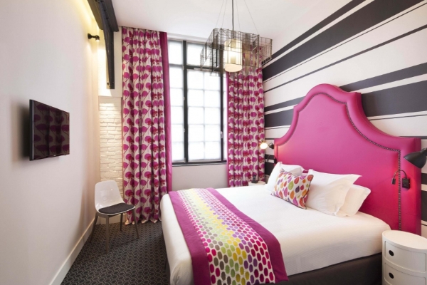 Hotel Fabric - a bed with pink and white bedding