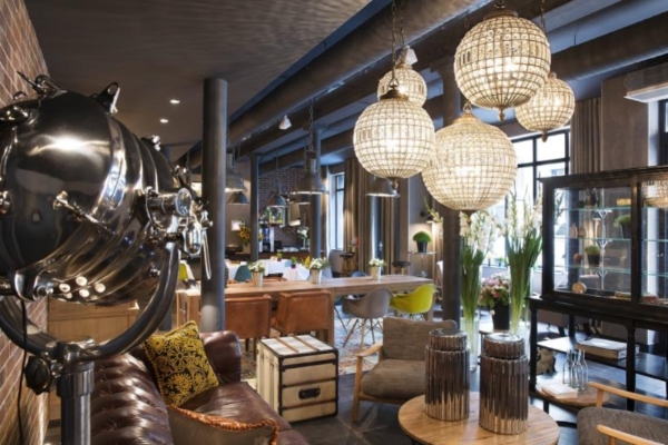 Hotel Fabric - a room with a large metal urn and chandeliers