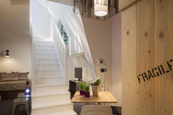 Hotel Fabric - a white staircase with a table and chairs