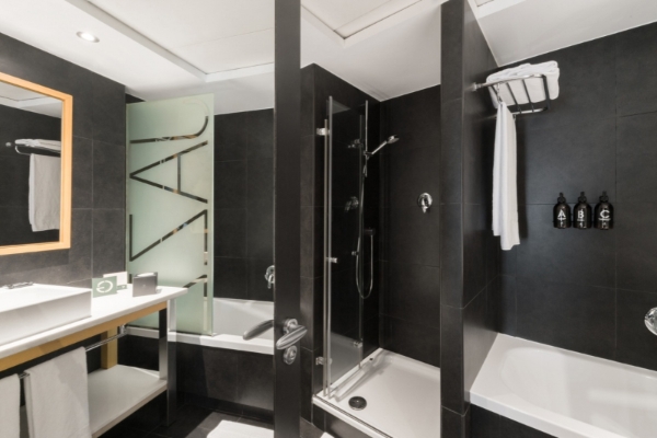 Hotel Jazz - a bathroom with a shower and bathtub