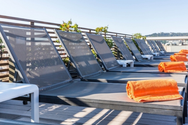 Hotel Jazz - a group of lounge chairs with a towel on the side