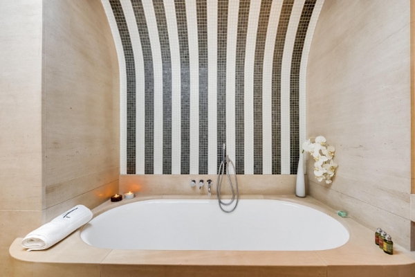 Hotel Le A - a bathtub with a black and white striped wall