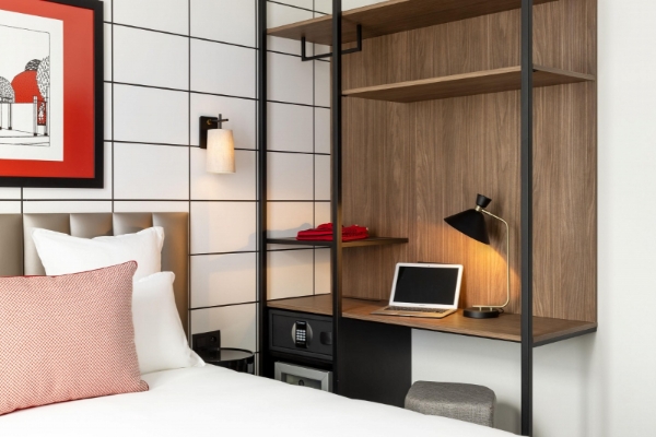 Hotel Moderniste - a bed with a laptop on it