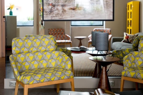 Hotel Signature St Germain des Pres - a yellow and black patterned chair next to a table