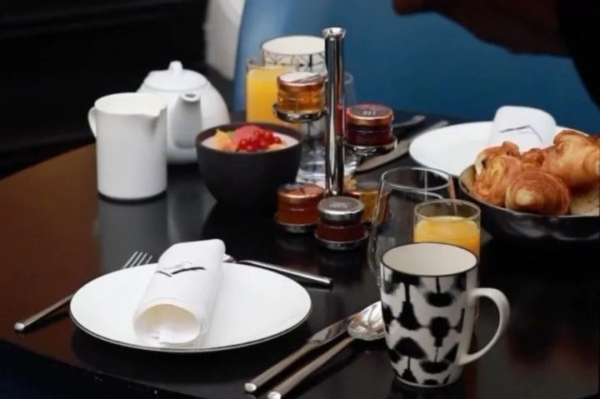 Hotel Vernet - a table with plates and glasses and food on it