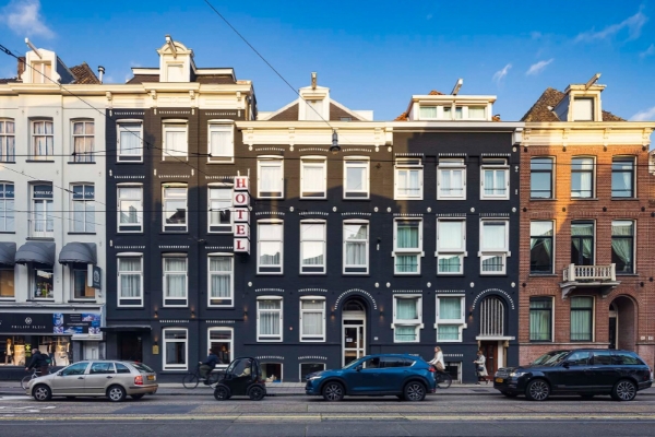 Huygens Place - a black building with white trim and a sign on it