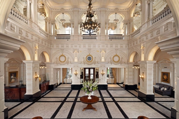 Intercontinental Amstel Amsterdam - a large white room with a table and chandelier