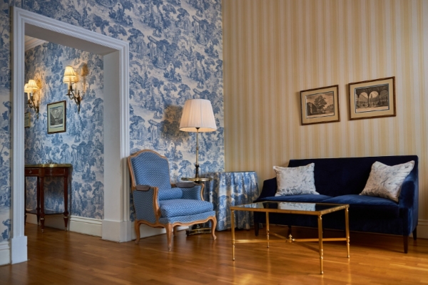 Intercontinental Amstel Amsterdam - a room with a blue couch and a blue sofa