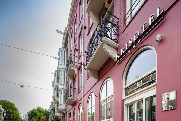 Krisotel - a red building with a balcony