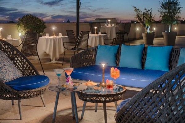 NH Collection Roma Palazzo Cinquecento - Rooftop terrace at night with panoramic views across Rome.