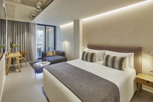 Ohla Eixample - a bedroom with a bed and a couch