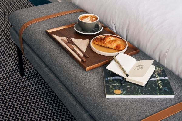 Page 8 - a tray with a cup of coffee and a croissant on it