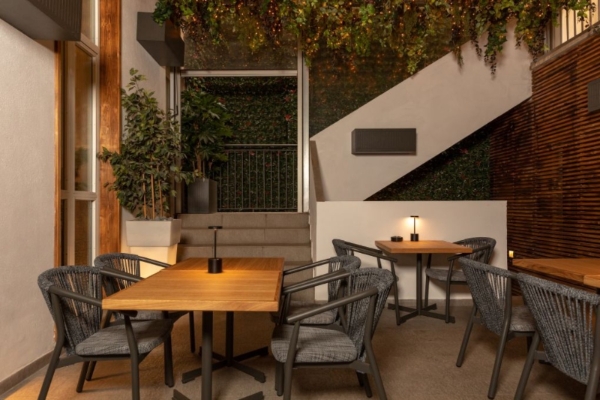 Rome Times Hotel - A small terrace lounge area with tables and chairs.