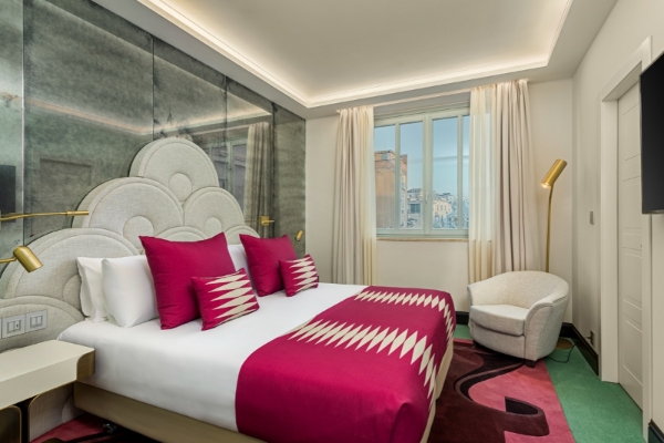 Room Mate Filippo - A luxury hotel room with cerise accents.