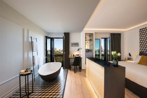 Serras Barcelona - a bathroom with a black and white counter and a tub