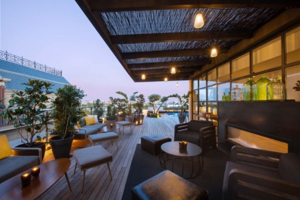 Serras Barcelona - a patio with a deck and chairs and a pool