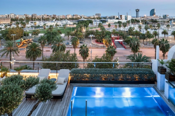 Serras Barcelona - a pool with a view of a city and boats