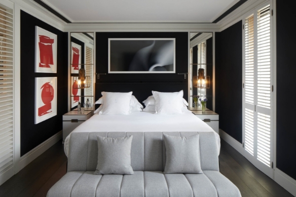 Seventy Barcelona - a bed with pillows in a room with art