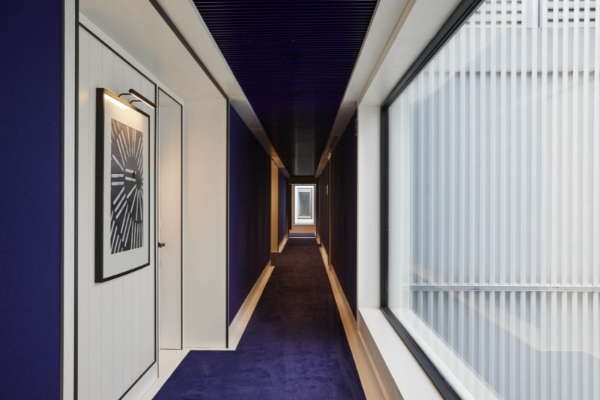 Seventy Barcelona - a long hallway with purple carpet and a blue ceiling