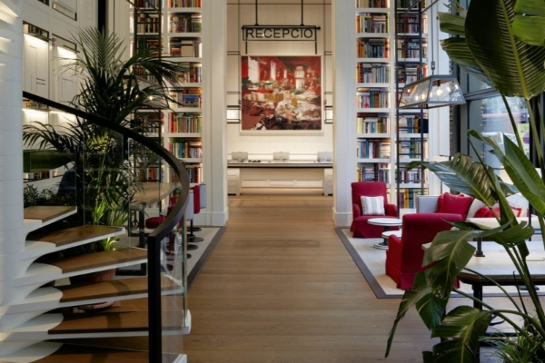 Seventy Barcelona - a room with bookshelves and a large picture on the wall