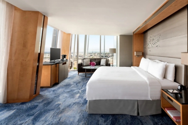 Shangri-La The Shard, London - a hotel room with a large bed and a television