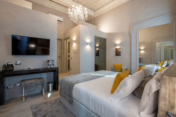 Terrace Pantheon Relais - A hotel room with contemporary furnishings and wall mounted TV.
