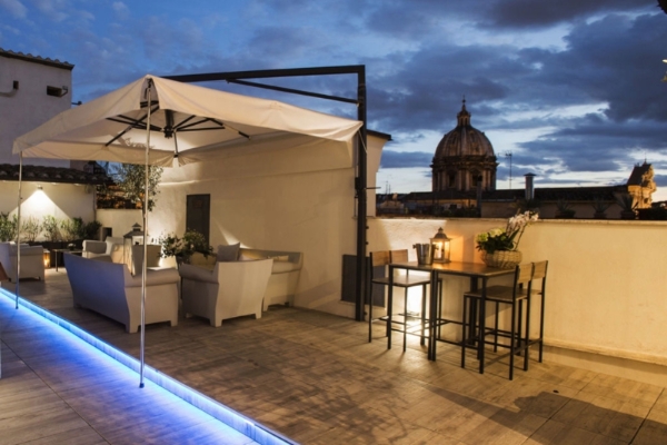 Terrace Pantheon Relais - The rooftop terrace at sunset with views over Rome.