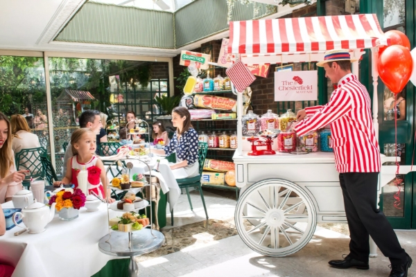 The Chesterfield Mayfair - a man in a striped shirt serving food to a girl