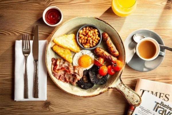 The Clermont, Charing Cross - a plate of breakfast with a cup of coffee and a newspaper